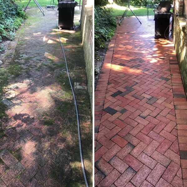 Before and after brick paver driveway restoration in Grand Rapids — moss and grime removed