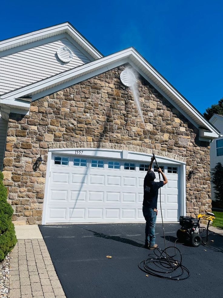 Professional residential power washing on a luxury home exterior